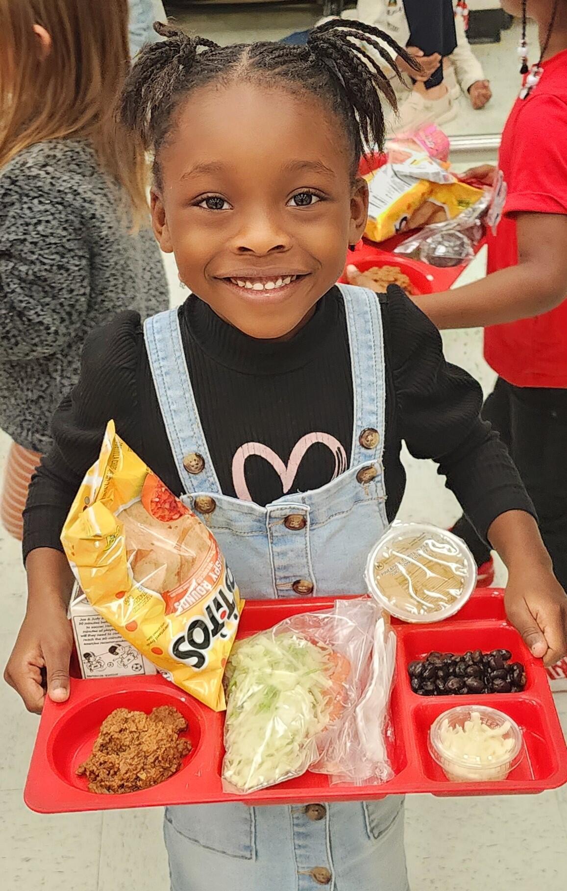 Ariyah Carter, Kindergarten Student at Cox, with lunch tray